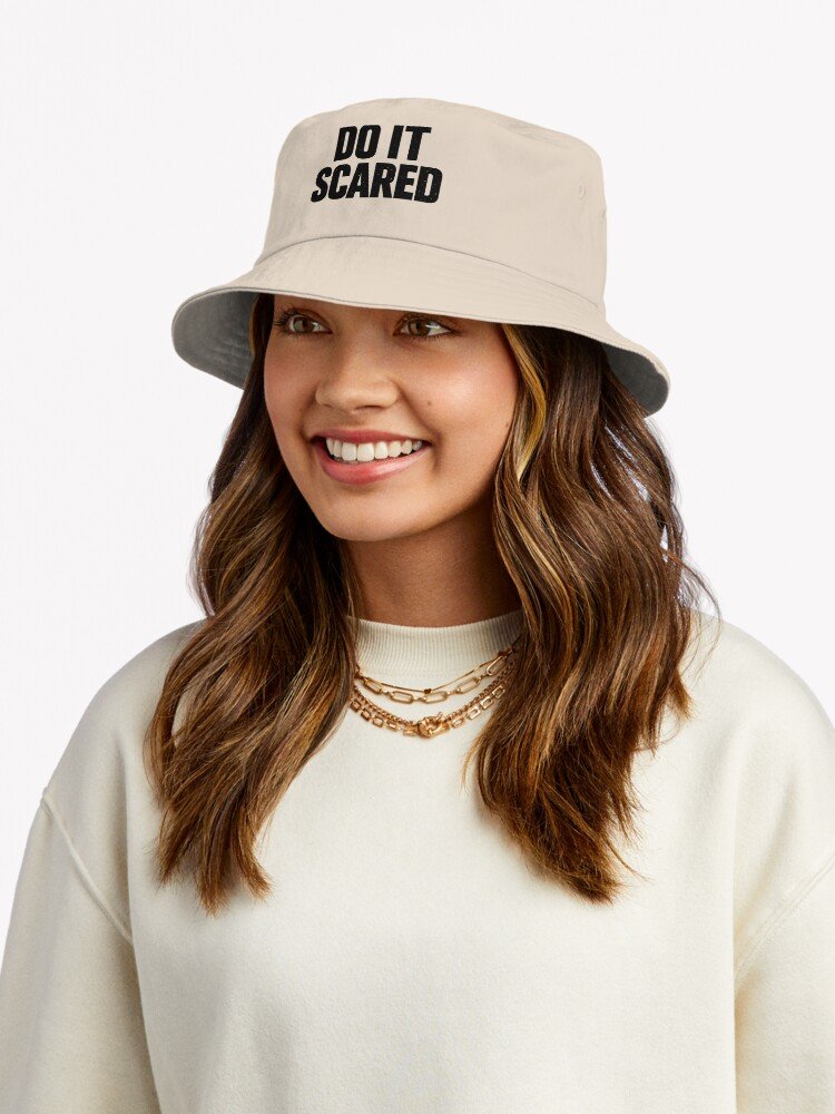 A woman wearing "Do It Scared" Bold Typography Bucket Hat