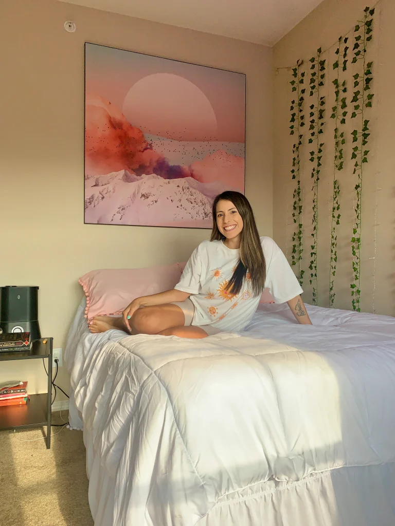 Landscape of Calmness wall art in a bedroom with a woman sitting on the bed