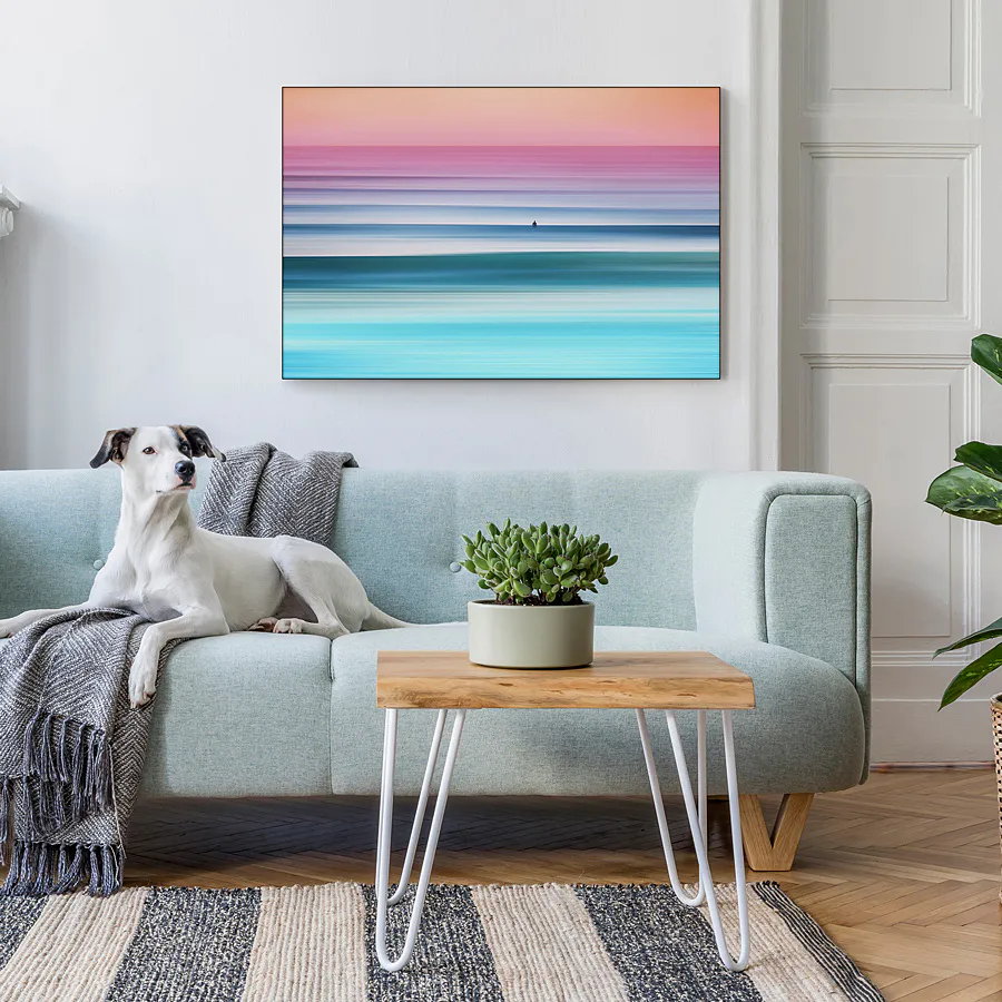 Swell Lines wall art above a sofa with a dog sitting on the sofa