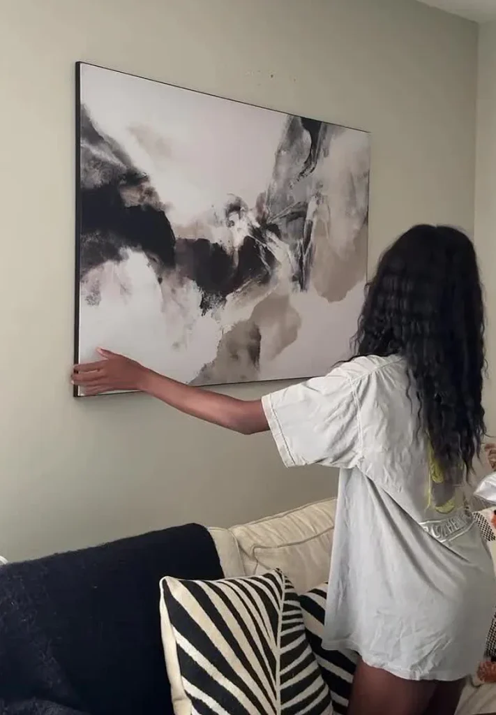 Vision of the Peak wall art getting hanged by a woman