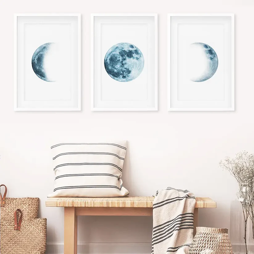 Three-piece blue moon phases wall art with white frames and mat
