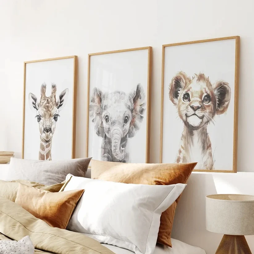 Three-piece framed neutral nursery wall art with watercolor baby giraffe, elephant, and lion